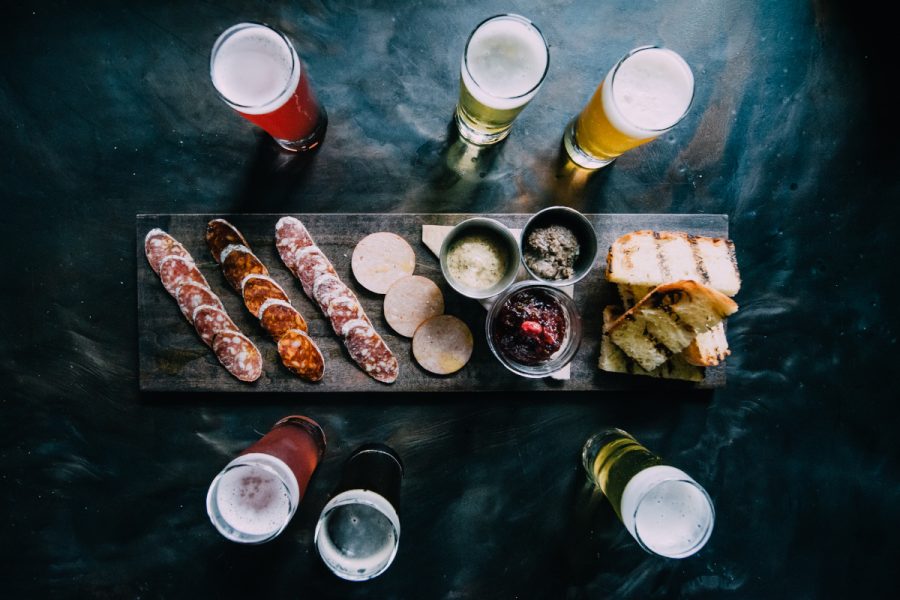 glasses of beer with a charcuterie board
