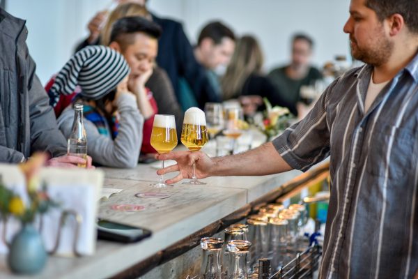 bartender serving glass of beer