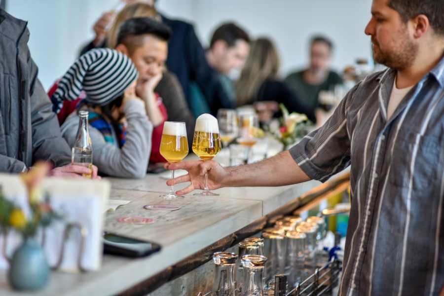 bartender serving glass of beer