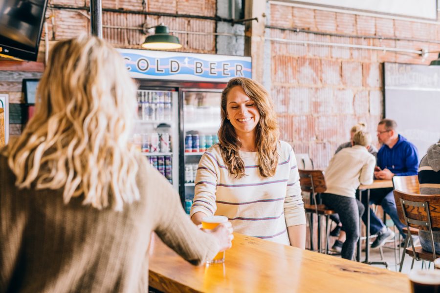 person purchasing beer in a taproom