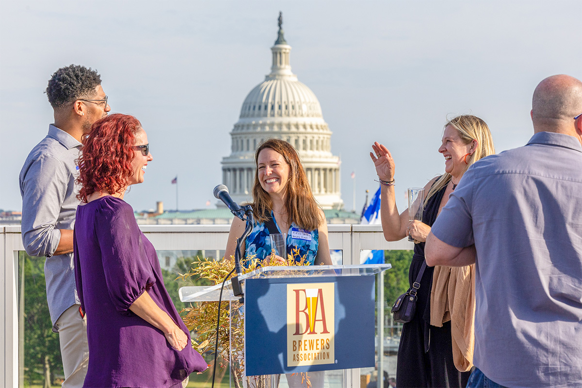 Brewers Association members at podium in front of the Capitol