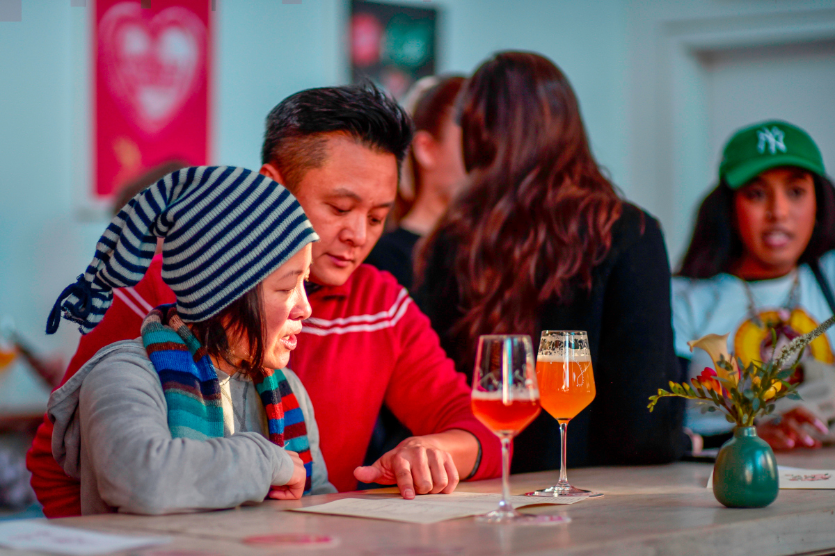 two brewery patrons looking at beer menu