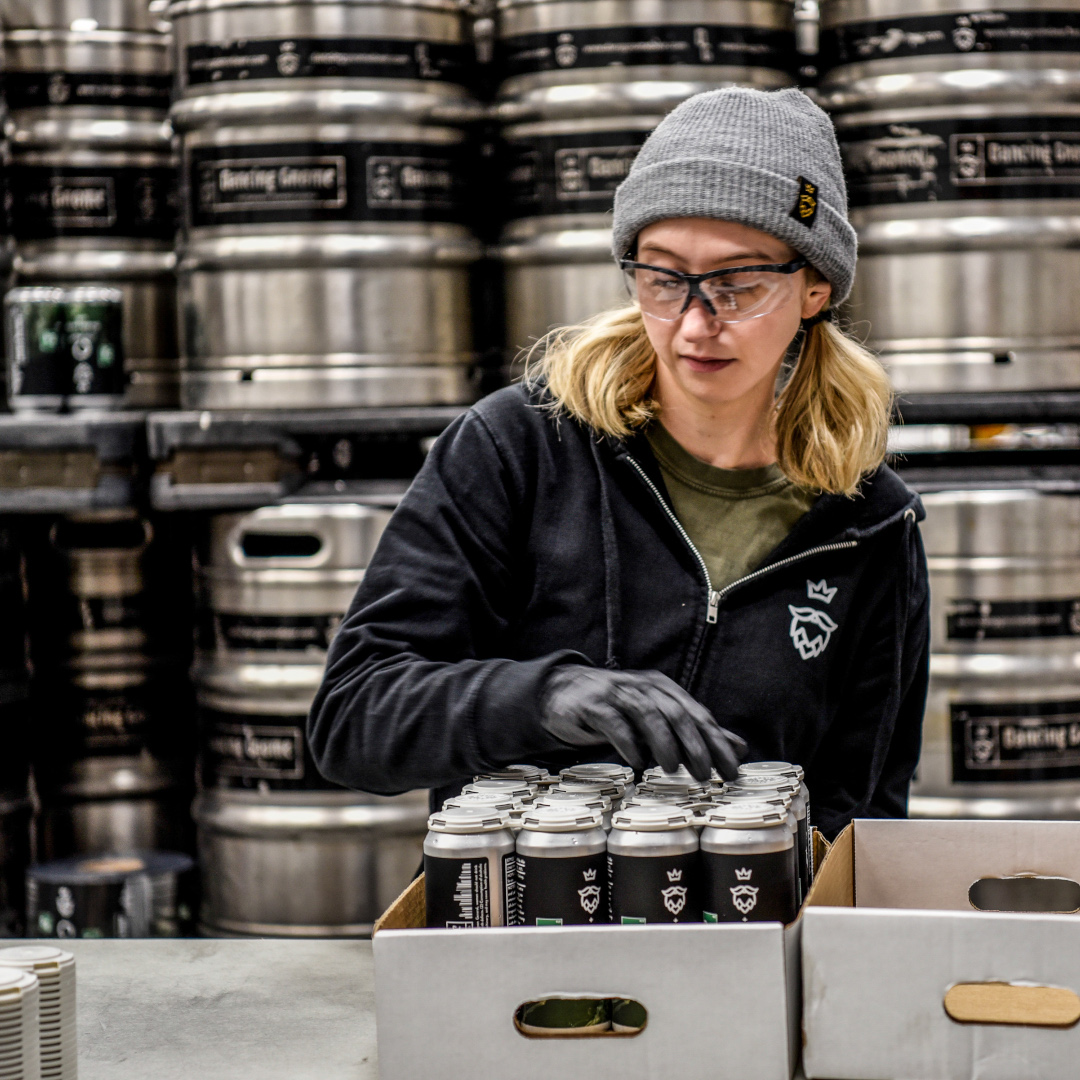 brewery working packing cans into cases