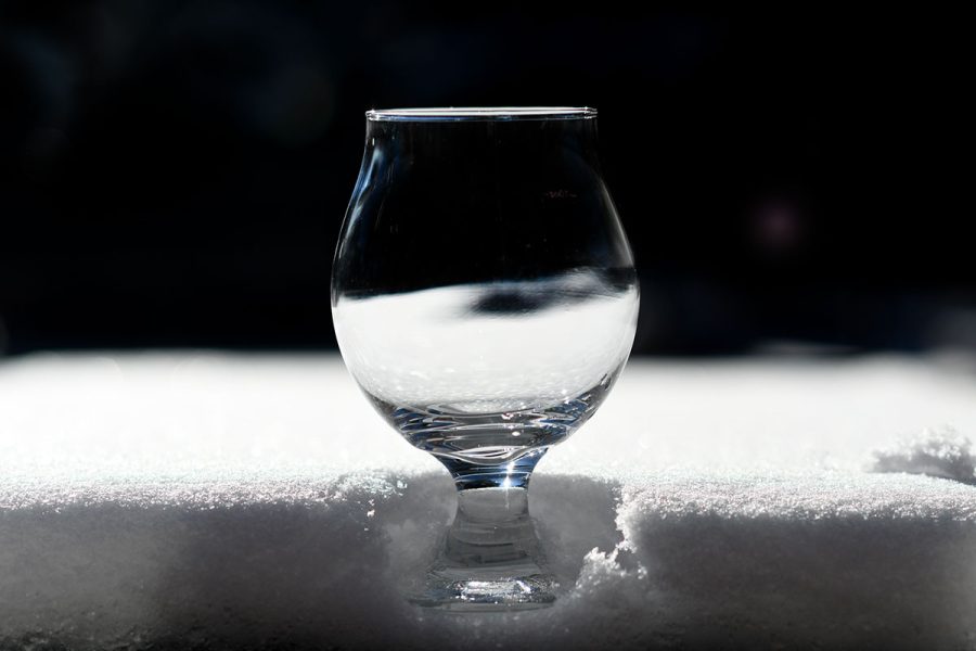 Empty glass of beer in snow