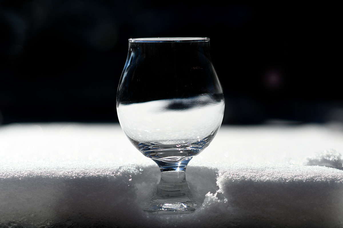 Empty glass of beer in snow