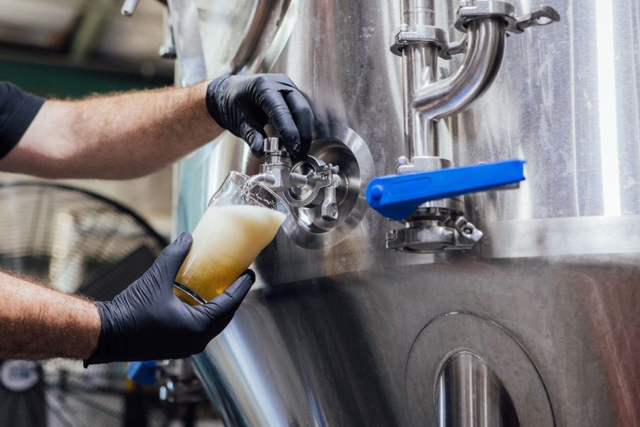 Beer sample being pulled from a fermenter
