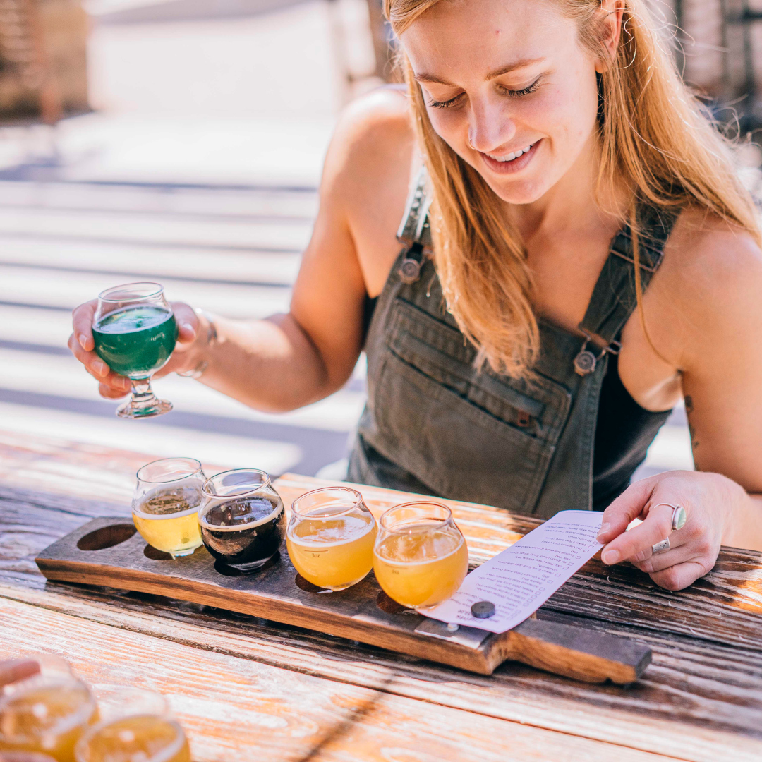 person enjoying flight of beer