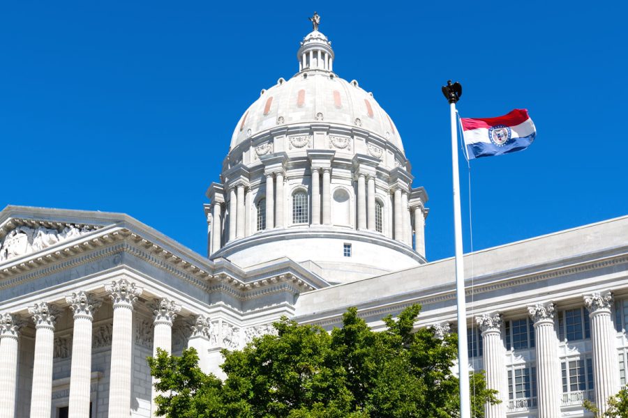 Missouri capitol building with state flag