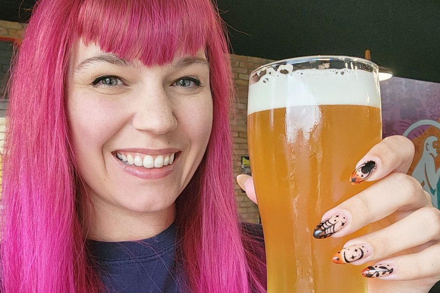 paige martin cheers-ing with a full beer