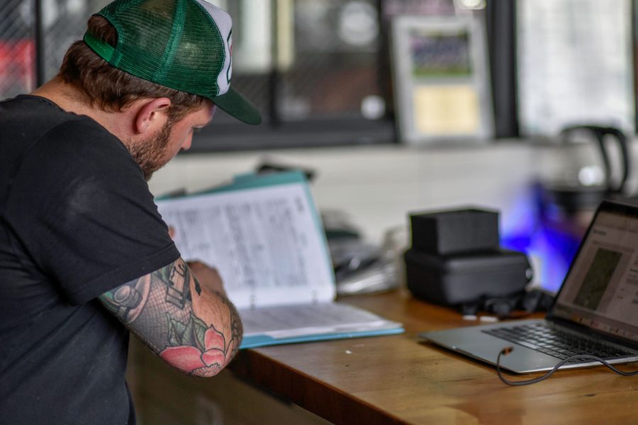 person in brewery looking at paperwork