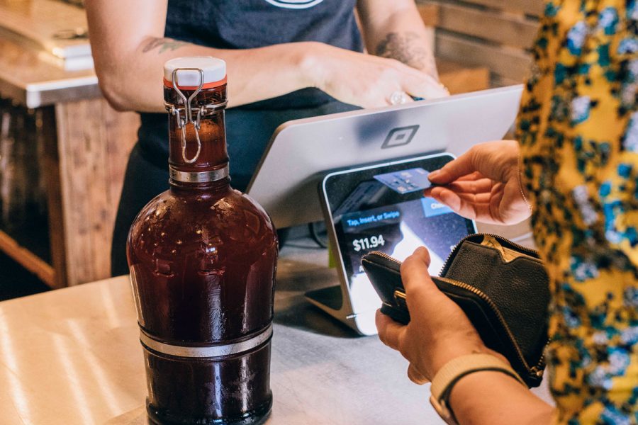 person paying for growler with credit card