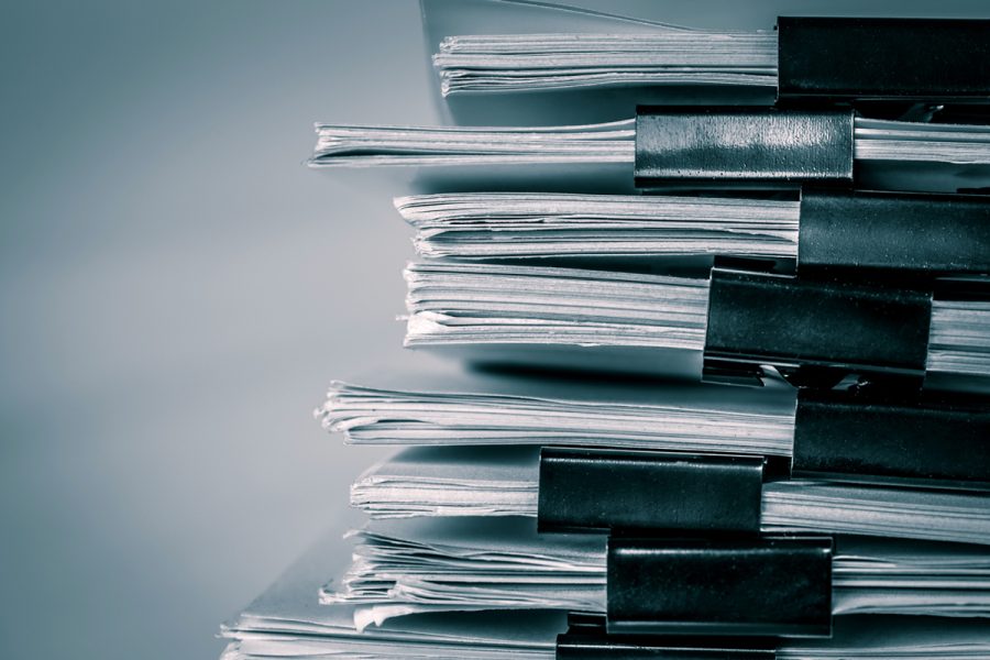 stacks of binder-clipped paperwork