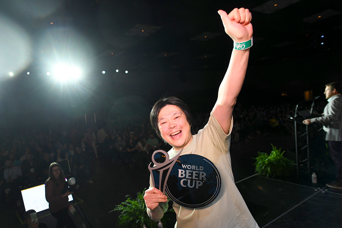 A winner celebrates their victory with arm stretched in the air